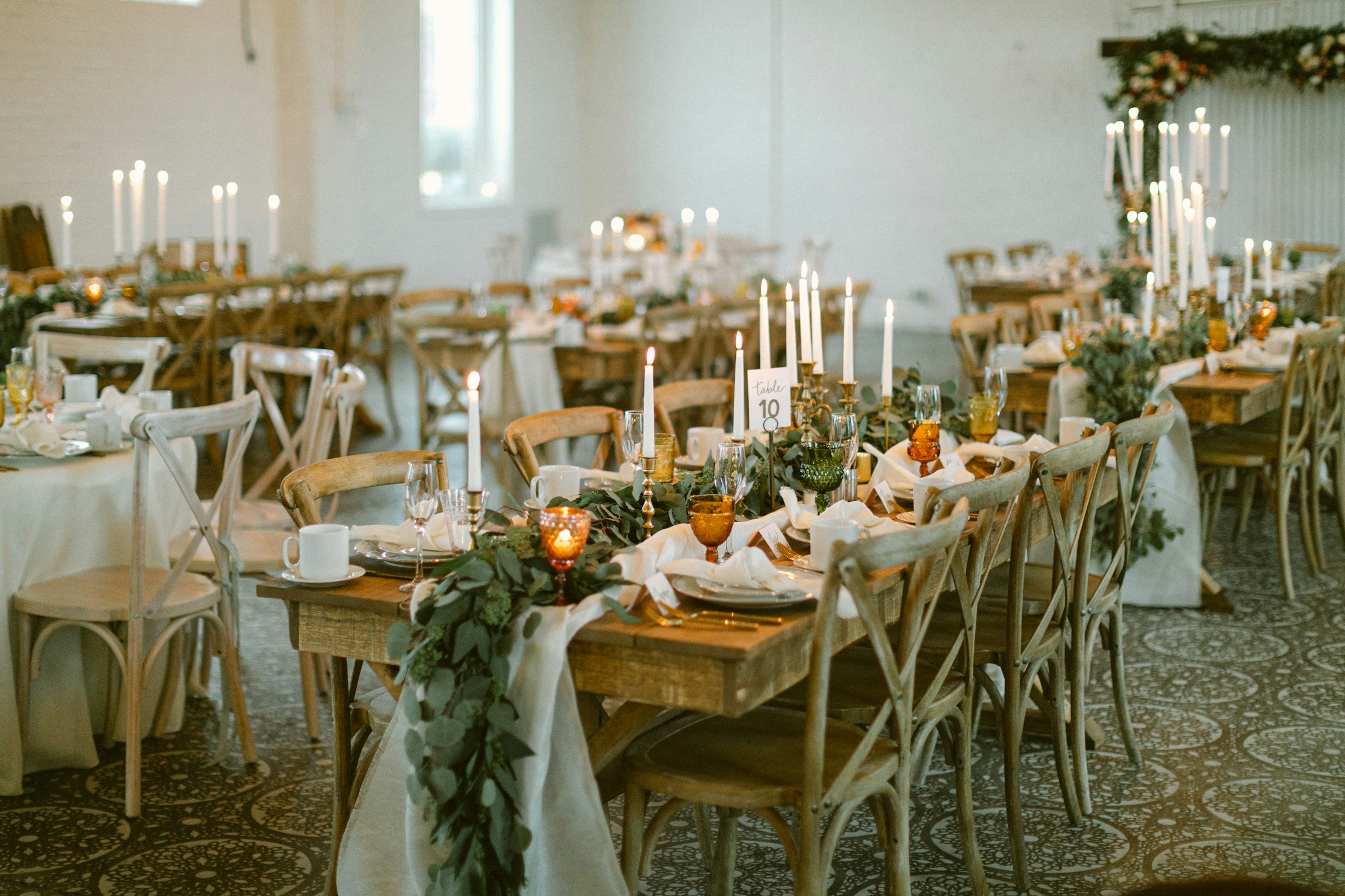 An elegantly styled celebration table with flowers and warm lighting